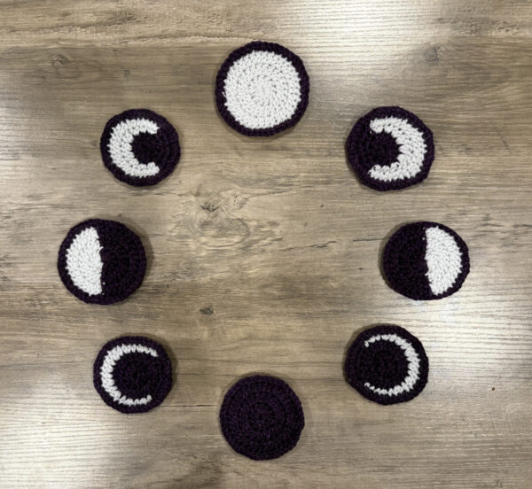 Eight phases of the moon sitting in a circle.